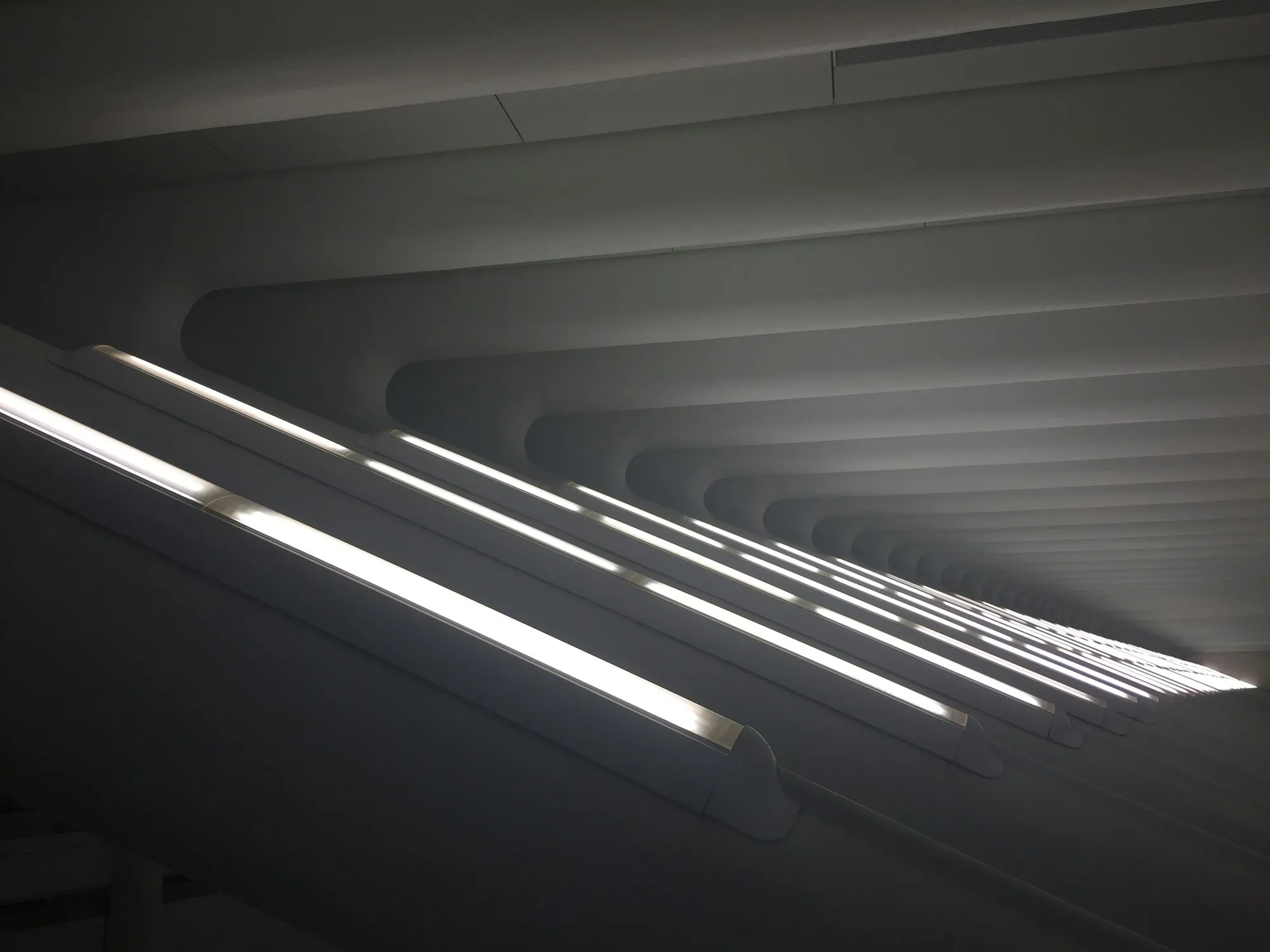Bands of daylight crossing a ribbed concrete ceiling